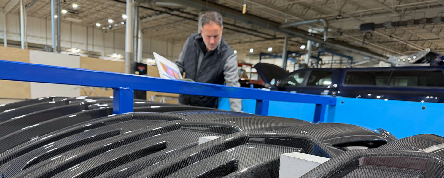 Prefix worker inspecting carbon fiber components