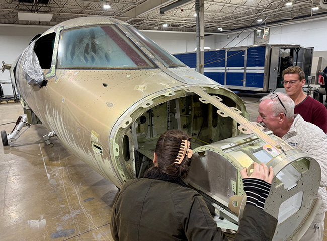 people viewing aircraft nose section