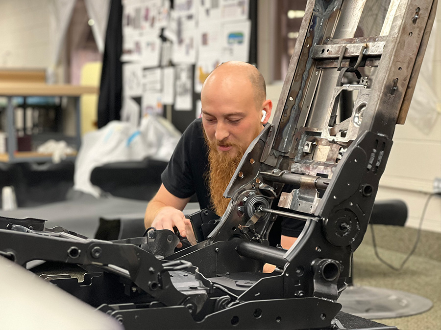 Prefix team member working on a seat frame